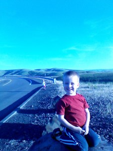 Levi poses perched on a rock while Amelia decides she wants to hitchhike.