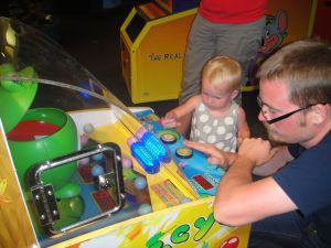 At Check E Cheese, feeding hungry frogs