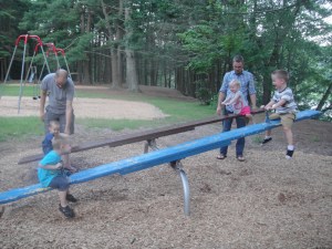 The Dads help with some teeter-totter competitions.