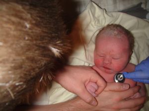 A few minutes after birth, holding Daddy's hand