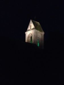 On our walk from the beach on our anniversary, this church had a green glow in its bell tower.