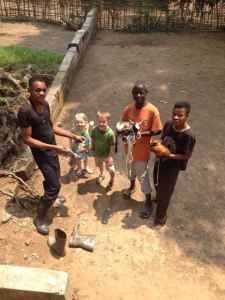 The guys that helped us get our new animals to bring home on the airplane - a rooster, a chicken, and a goat.